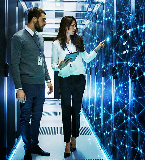 female and nale it engineers discussing technical details in a working data server room with internet connection visualisation